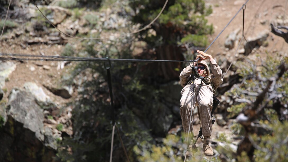 Cpl. Jordan Yearsley, combat engineer, Engineer Platoon, Headquarters and Service Company, Ground Combat Element Integrated Task Force, crosses a gorge on a rope during a Marine Corps Operational Test and Evaluation Activity assessment aboard Marine Corps Mountain Warfare Training Center Bridgeport, California, May 5, 2015. From October 2014 to July 2015, the GCEITF will conduct individual and collective level skills training in designated ground combat arms occupational specialties in order to facilitate the standards-based assessment of the physical performance of Marines in a simulated operating environment performing specific ground combat arms tasks.