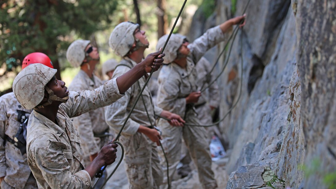 Marines with the Ground Combat Element Integrated Task Force belay their partners during the 40-foot cliff face climbing event of a during a Marine Corps Operational Test and Evaluation Activity assessment aboard Marine Corps Mountain Warfare Training Center Bridgeport, California, May 5, 2015. From October 2014 to July 2015, the GCEITF will conduct individual and collective level skills training in designated ground combat arms occupational specialties in order to facilitate the standards-based assessment of the physical performance of Marines in a simulated operating environment performing specific ground combat arms tasks.