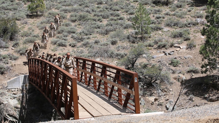 Marines with the Ground Combat Element Integrated Task Force depart the gorge crossing area during a Marine Corps Operational Test and Evaluation Activity assessment aboard Marine Corps Mountain Warfare Training Center Bridgeport, California, May 5, 2015. From October 2014 to July 2015, the GCEITF will conduct individual and collective level skills training in designated ground combat arms occupational specialties in order to facilitate the standards-based assessment of the physical performance of Marines in a simulated operating environment performing specific ground combat arms tasks. 