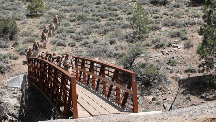 Marines with the Ground Combat Element Integrated Task Force depart the gorge crossing area during a Marine Corps Operational Test and Evaluation Activity assessment aboard Marine Corps Mountain Warfare Training Center Bridgeport, California, May 5, 2015. From October 2014 to July 2015, the GCEITF will conduct individual and collective level skills training in designated ground combat arms occupational specialties in order to facilitate the standards-based assessment of the physical performance of Marines in a simulated operating environment performing specific ground combat arms tasks. 