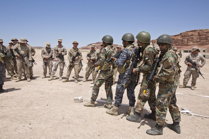 Jordanian Armed Forces soldiers demonstrate military operations in urban terrain tactics for U.S. Marines with 2nd Battalion, 2nd Marine Regiment, during Exercise Eager Lion, in Al Quweyrah, Jordan, May 7, 2015. Eager Lion is a recurring, multinational exercise designed to strengthen military-to-military relationships, increase interoperability between partner nations, and enhance regional security and stability. (U.S. Marine Corps photo by Cpl. Sean Searfus CE MARFOR CENTCOM FWD COMCAM/ Released)
