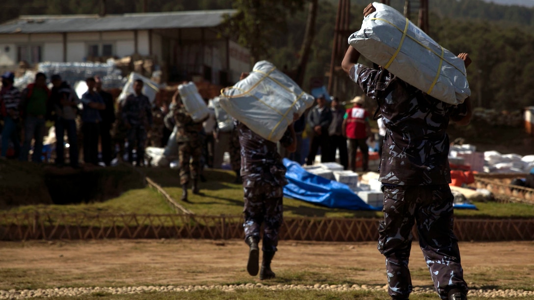 Nepalese military service members unload supplies from a UH-1Y Huey in Charikot, Nepal, May 5. Marines with Marine Light Attack Helicopter Squadron 469 and Marine Medium Tilt Rotor Squadron 262 carried supplies in a UH-1Y Huey and MV-22 Ospreys to Charikot, Nepal. The supplies will provide Nepalese people with shelter after a 7.8 magnitude earthquake struck central Nepal, April 25, causing fatalities, injuries and significant damage. The government of Nepal declared a state of emergency and requested international assistance. The U.S. military, at the direction of the U.S. Agency for International Development, will continue to support Nepal as needed. HMLA-469 and VMM-262 are attached to Marine Aircraft Group 36, 1st Marine Aircraft Wing, III Marine Expeditionary Force.