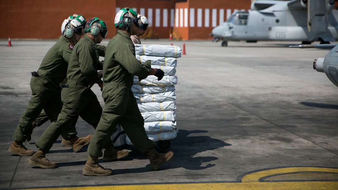 U.S. Marines bring supplies over to the UH-1Y Huey at the Tribhuvan International Airport in Kathmandu, Nepal, May 5. Marines with Marine Light Attack Helicopter Squadron 469 and Marine Medium Tilt Rotor Squadron 262 carried supplies in a UH-1Y Huey and MV-22 Ospreys to Charikot, Nepal. The supplies will provide Nepalese people with shelter after a 7.8 magnitude earthquake struck central Nepal, April 25, causing fatalities, injuries and significant damage. The government of Nepal declared a state of emergency and requested international assistance. The U.S. military, at the direction of the U.S. Agency for International Development, will continue to support Nepal as needed. HMLA-469 and VMM-262 are attached to Marine Aircraft Group 36, 1st Marine Aircraft Wing, III Marine Expeditionary Force. 