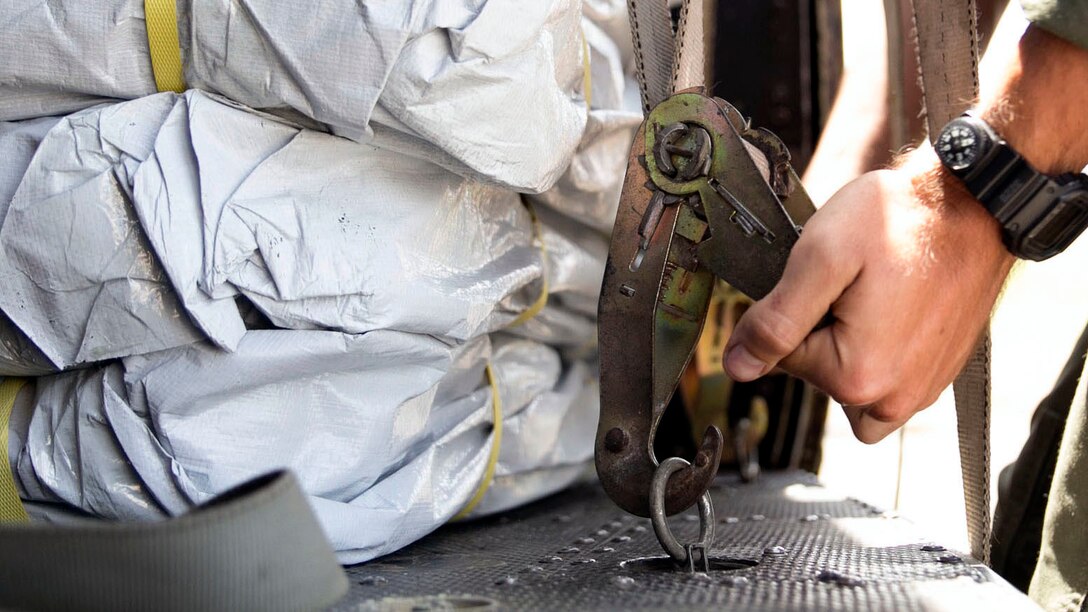 Staff Sgt. Joseph Thomas ratchets down supplies in a UH-1Y Huey prior to departure at the Tribhuvan International Airport in Kathmandu, Nepal, May 5. Marines with Marine Light Attack Helicopter Squadron 469 and Marine Medium Tilt Rotor Squadron 262 carried supplies in a UH-1Y Huey and MV-22 Ospreys to Charikot, Nepal. The supplies will provide Nepalese people with shelter after a 7.8 magnitude earthquake struck central Nepal, April 25, causing fatalities, injuries and significant damage. The government of Nepal declared a state of emergency and requested international assistance. The U.S. military, at the direction of the U.S. Agency for International Development, will continue to support Nepal as needed. HMLA-469 and VMM-262 are attached to Marine Aircraft Group 36, 1st Marine Aircraft Wing, III Marine Expeditionary Force. Thomas is a UH-1Y Crew Chief with HMLA-469 from Allentown, Pennsylvania.