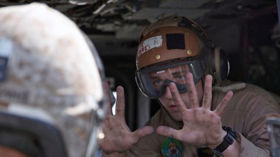 Lance Cpl. Michael Borzekofski holds up ten fingers to show the number of supplies they had loaded into a UH-1Y Huey at the Tribhuvan International Airport in Kathmandu, Nepal, May 5. Marines with Marine Light Attack Helicopter Squadron 469 and Marine Medium Tilt Rotor Squadron 262 carried supplies in a UH-1Y Huey and MV-22 Ospreys to Charikot, Nepal. The supplies will provide Nepalese people with shelter after a 7.8 magnitude earthquake struck central Nepal, April 25, causing fatalities, injuries and significant damage. The government of Nepal declared a state of emergency and requested international assistance. The U.S. military, at the direction of the U.S. Agency for International Development, will continue to support Nepal as needed. HMLA-469 and VMM-262 are attached to Marine Aircraft Group 36, 1st Marine Aircraft Wing, III Marine Expeditionary Force. Borzekofski is a tilt rotor crew chief with VMM-262 from Kearney, Nebraska.
