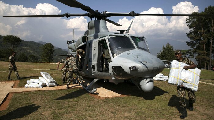 Nepalese military service members unload supplies from a UH-1Y Huey in Charikot, Nepal, May 5, Nepal, May 5. Marines with Marine Light Attack Helicopter Squadron 469 and Marine Medium Tilt Rotor Squadron 262 carried supplies in a UH-1Y Huey and MV-22 Ospreys to Charikot, Nepal. The supplies will provide Nepalese people with shelter after a 7.8 magnitude earthquake struck central Nepal, April 25, causing fatalities, injuries and significant damage. The government of Nepal declared a state of emergency and requested international assistance. The U.S. military, at the direction of the U.S. Agency for International Development, will continue to support Nepal as needed. HMLA-469 and VMM-262 are attached to Marine Aircraft Group 36, 1st Marine Aircraft Wing, III Marine Expeditionary Force. 
