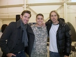 Capt. Brett Haker, a maintenance officer with the Alaska National Guard's Army Aviation Support Facility, poses with John Krasinski and Dax Shepard during a meet and greet event Nov. 6, 2010. The two actors are starring in "Everybody Loves Whales," for which Haker provided technical advice to one of the stars portraying a pilot.