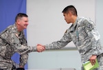 Maj. Eric Verzola, an Operations Group Alpha public affairs observer/trainer, meets Maj. Gen. Eddy Spurgin, the Texas National Guard's 36th Infantry Division commanding general, prior to his DVIDS training for the unit’s Mission Rehearsal Exercise at Joint Base Lewis-McChord, Wash.