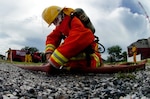 A firefighter from the Port of Laem Chabang in Pattaya, Thailand, secures a hose fitting during a training exercise with the Washington National Guard near the port on May 19, 2009. A roundtable recently recommended enhancing the National Guard's State Partnership Program as a tool for citizen diplomacy.