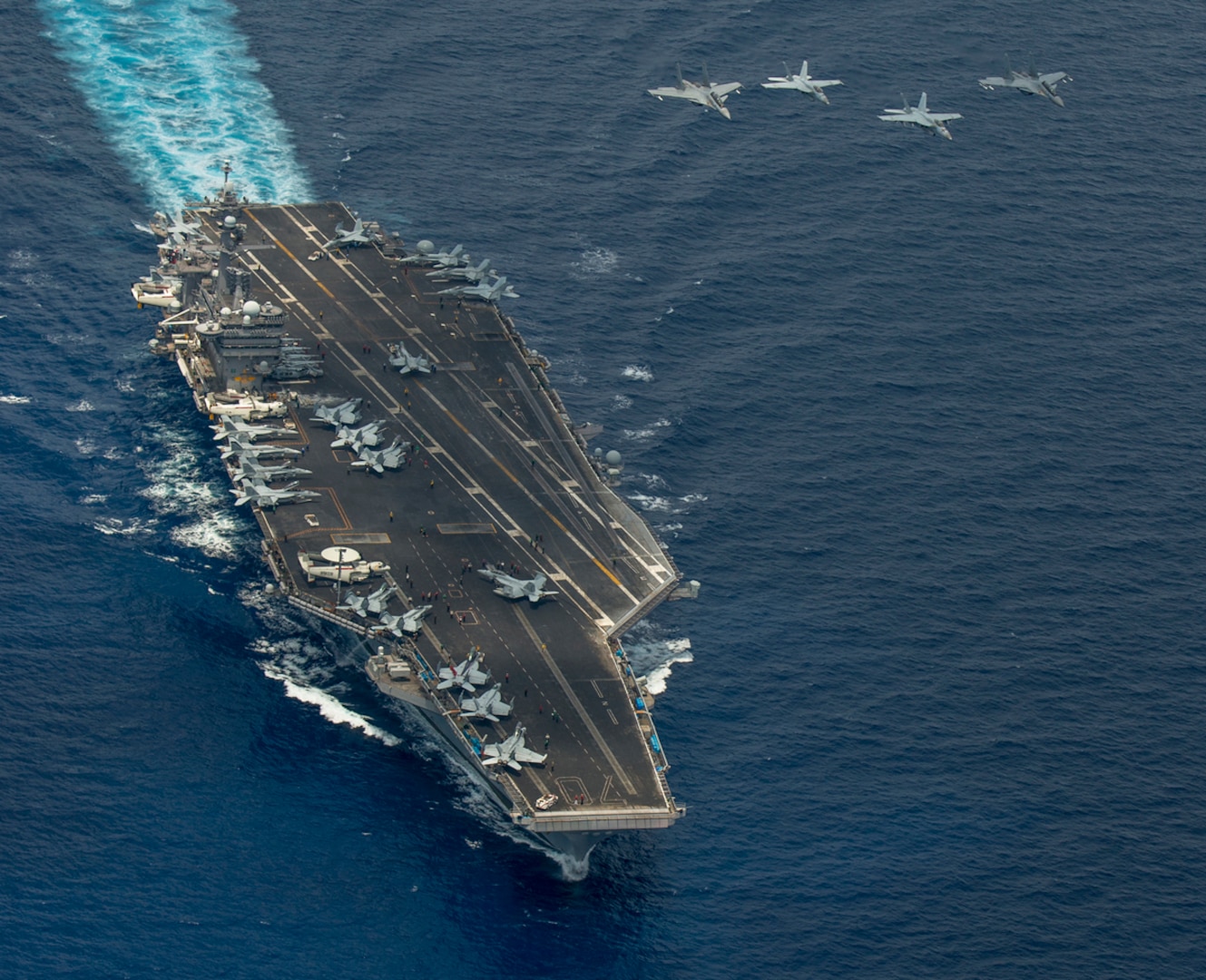 SOUTH CHINA SEA (May 10, 2015) - Two F/A-18 Super Hornets and two Royal Malaysian Air Force Mig 29 Fulcrums fly in formation above the aircraft carrier USS Carl Vinson (CVN 70). The Carl Vinson Strike group is deployed to 7th Fleet area of operations supporting security and stability in the Indo-Asia-Pacific region. 