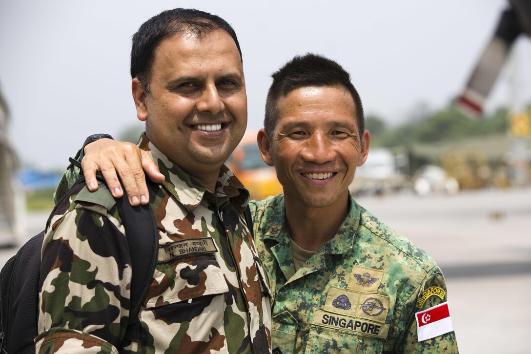 Nepalese Army Maj. Niranjar Bharlari, liaisons officer and Singapore Army Master Warrant Officer Tengkee Leong, at Tribhuvan International Airport, Kathmandu, Nepal, May 10. The Nepalese government requested assistance after a 7.8 magnitude earthquake struck the country April 25. The U.S. government ordered JTF 505 to provide unique capabilities to assist Nepal.