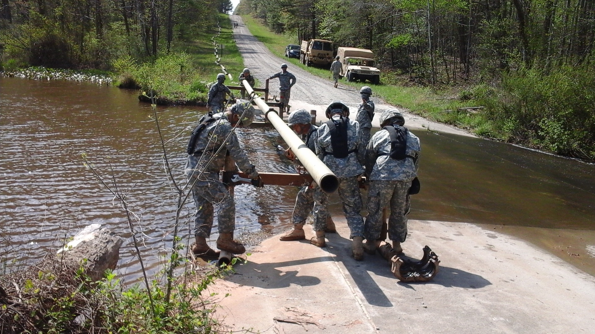 In this photo, members of the Korean Service Corps participate in the Fiscal Year 2015 U.S. Forces Command Petroleum Training Module field exercise at Fort Pickett, Va. The 35-member KSC team practiced its ability to rapidly establish a series of pipes to simulate a petroleum distribution system during a contingency situation. 