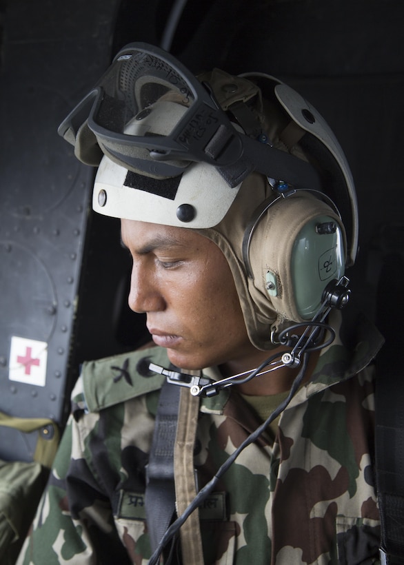 A Nepalese soldier looks over the Sindhuli District, Nepal from a U.S. Marine Corps UH-1Y Venom assigned to Joint Task Force 505, May 10. The Nepalese government requested the U.S. government’s assistance after a 7.8 magnitude earthquake struck the country, April 25. The U.S. government ordered JTF 505 to provide unique capabilities to assist Nepal.