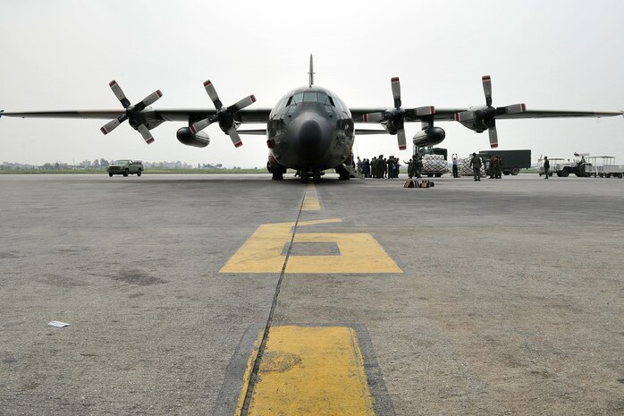 KATHMANDU, Nepal  (May 9, 2015) - Nepalese army soldiers and U.S. Air Force 36th Contingency Response Group Airmen work with Republic of Singapore Air Force members to unload relief supplies from an RSAF C-130 Hercules at the Tribhuvan International.  The Nepalese army and Airmen worked together to process 537,816 pounds of cargo in a 24-hour period from 13 aircraft delivering relief supplies delivered in response to a magnitude 7.8 earthquake that struck the nation April 25, 2015. 