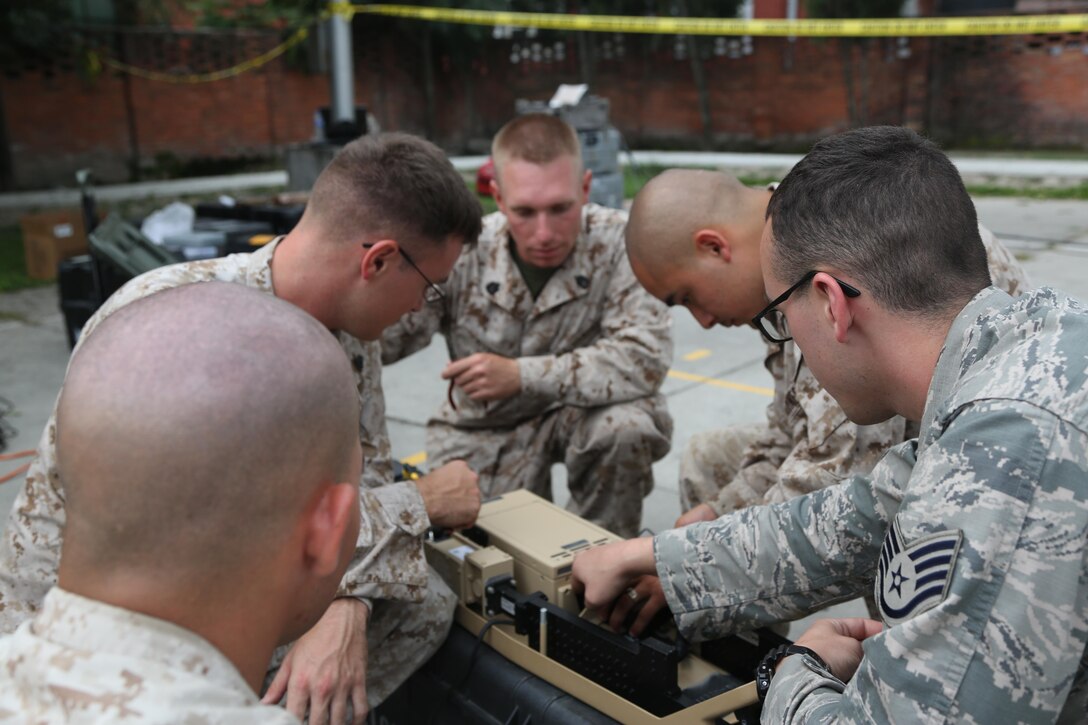 U.S. Service members from Joint Task Force 505 work together to repair a Hawkeye III Lite satellite communication system at the U.S. Embassy Annex in Kathmandu, Nepal, May 8. The Nepalese government requested assistance after a 7.8 magnitude earthquake struck the country, April 25. The U.S. government ordered JTF 505 to provide unique capabilities to assist Nepal.
