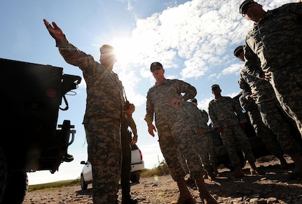 Army Maj. Gen. Peter Aylward, special assistant to the Chief, National Guard Bureau, center, looks on as a New Mexico Army National Guard Soldier explains the layout of an Entry Identification Site manned by New Mexico Guard troops along the Southwest border in support of U.S. Customs and Border Patrol agents, Sept. 14, 2010. About 1,200 National Guard Soldiers and Airmen provide administrative, logistical, engineering and other support to CBP agents.