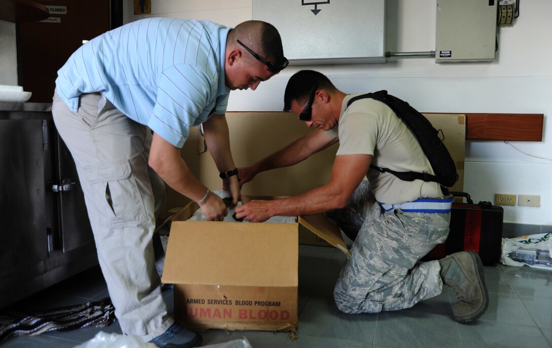 U.S. Navy Petty Officer 1st Class John Gromer, an emergency medical technician, and U.S. Air Force Tech. Sgt. Terrence Wright, an air transportation craftsman, package a cooler containing units of blood with ice at the intermediate staging base at Utapao Royal Thai Navy Airfield, Thailand, May 10, 2015. The blood was part of a shipment of items sent to Kathmandu, Nepal, to aid in the continuous support of the humanitarian assistance and disaster relief efforts. Following the magnitude 7.8 earthquake that struck the nation April 25, the U.S. military sent airmen, Marines, soldiers and sailors as part of Joint Task Force 505 to support the HA/DR mission at the direction of U.S. Agency for International Development.