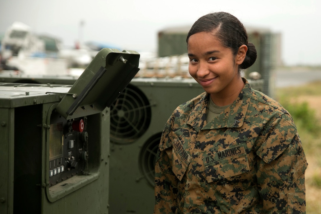 U.S. Marine Lance Cpl. Melisa Santana, from Middletown, New York, stands next to a generator at the Tribhuvan International Airport in Kathmandu, Nepal, May 8. Santana is contributing to an international joint-service humanitarian aid mission after a 7.8 magnitude earthquake hit Nepal, April 25. She is an electrician with Marine Wing Support Squadron 172, Marine Aircraft Group 36, 1st Marine Aircraft Wing, III Marine Expeditionary Force.