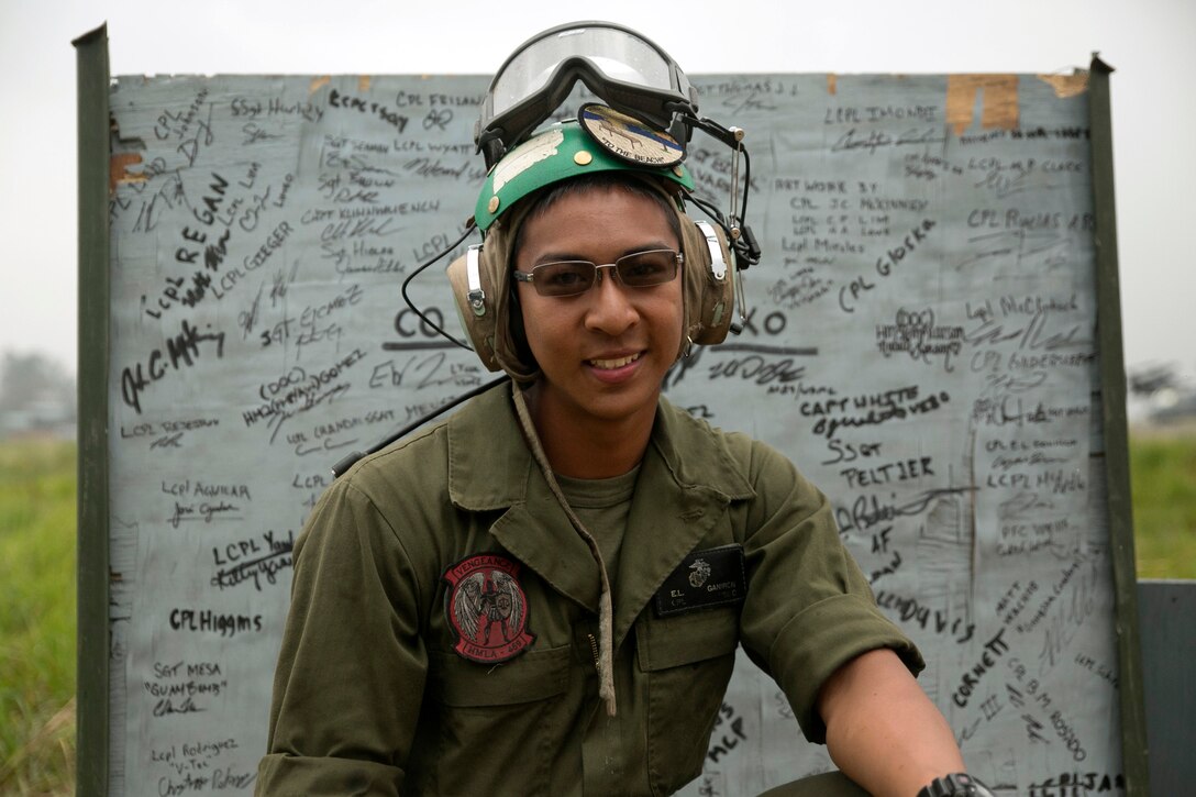 U.S. Marine Cpl. Eugene Ganiron, from Pahoa, Hawaii, kneels in front of a sign at the Tribhuvan International Airport in Kathmandu, Nepal, May 9. Ganiron is an avionics electronics technician with Marine Light Attack Helicopter Squadron 469 currently contributing to the joint-service humanitarian aid mission in Nepal under JTF 505, which is composed of service members from across the U.S. military. The task force responded with joint capabilities and relief supplies after the Nepalese government requested assistance from U.S. Agency for International Development following the 7.8 magnitude earthquake that struck their country April 25. 