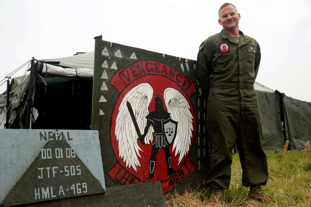 U.S. Marine Staff Sgt. Niel J. Peltier, from Saugerties, New York, stands in front of a Joint Task Force 505 and HMLA-469 Vengeance sign at the Tribhuvan International Airport in Kathmandu, Nepal, May 9. Peltier is an airframes mechanic staff non-commissioned officer in charge with Marine Light Attack Helicopter Squadron 469 currently contributing to the joint-service humanitarian aid mission in Nepal under JTF 505, which is composed of service members from across the U.S. military. The task force responded with joint capabilities and relief supplies after the Nepalese government requested assistance from U.S. Agency for International Development following the 7.8 magnitude earthquake that struck their country April 25.