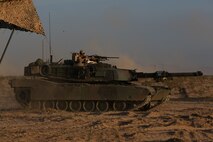 Marines with Company A, 1st Tank Battalion, 1st Marine Division, nicknamed “America’s Company,” put their M1A1 abrams main battle tank into a defensive position during Exercise Desert Scimitar aboard Marine Corps Air Ground Combat Center Twentynine Palms, Calif., April 11, 2015. The training gave the Marines the opportunity to refine and rehearse essential combat skills needed in a battlefield environment. Desert Scimitar is an annual exercise that includes elements from the I Marine Expeditionary Force. The exercise focused on conventional operations and provided realistic training that prepared Marines for overseas operations. (U.S. Marine Corps photo by Sgt. Christopher J. Moore/Released)