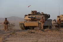 Lance Cpl. Patrick, left, loader, Company A, 1st Tank Battalion, 1st Marine Division, and a native of Houston, Texas, ground guides his tank named “Star Lord” during Exercise Desert Scimitar aboard Marine Corps Air Ground Combat Center Twentynine Palms, Calif., April 10, 2015. The training gave the Marines the opportunity to refine and rehearse essential combat skills needed in a battlefield environment. Desert Scimitar is an annual exercise that includes elements from the I Marine Expeditionary Force. The exercise focused on conventional operations and provided realistic training that prepared Marines for overseas operations. (U.S. Marine Corps photo by Sgt. Christopher J. Moore/Released)