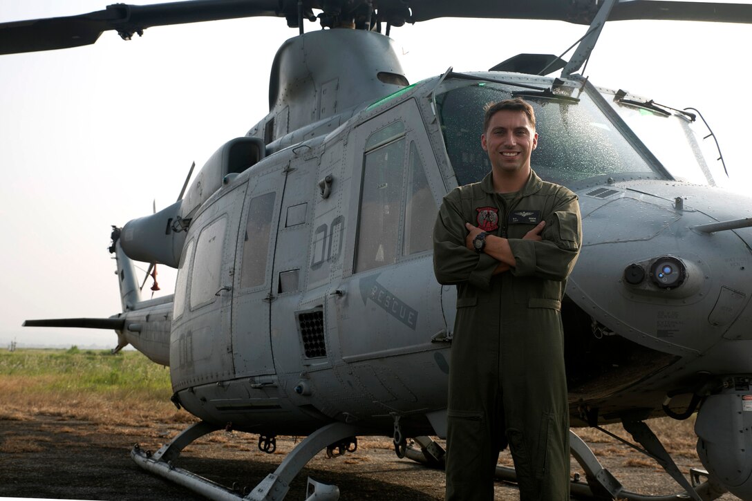 U.S. Marine Capt. Michael Bebow, stands in front of a Nepal Joint Task Force 505 and HMLA 469 Vengeance sign at the Tribhuvan International Airport in Kathmandu, Nepal, May 9. Bebow is a pilot and a ground safety officer with Marine Light Attack Helicopter Squadron 469 currently contributing to the joint-service humanitarian aid mission in Nepal under JTF 505, which is composed of service members from across the U.S. military. The task force responded with joint capabilities and relief supplies after the Nepalese government requested assistance from U.S. Agency for International Development following the 7.8 magnitude earthquake that struck their country April 25.