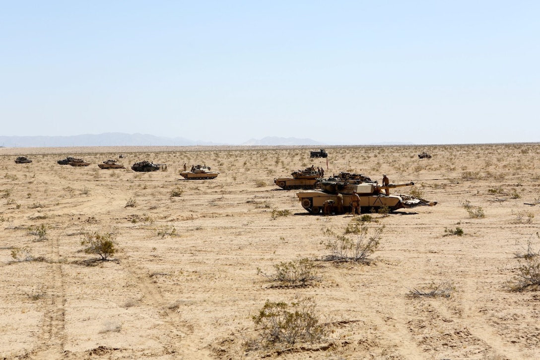 A line of M1A1 Abrams Main Battle Tanks are put into a defensive position during Exercise Desert Scimitar aboard Marine Corps Air Ground Combat Center Twentynine Palms, Calif., April 12, 2015. Desert Scimitar enables 1st Marine Division to test and refine its command and control capabilities and ensures 1st Marine Division units remain committed to consistently improving the quality of their training efforts and their resultant war fighting capabilities.