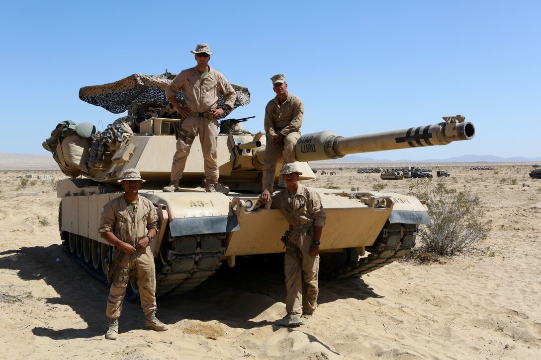 Clockwise from top left, 1st Lieutenant John Neail, tank commander, Cpl. Christian Bills, gunner, Lance Cpl. Robert Benaridez driver, Lance Cpl. Patrick Bellinger, loader, the crew for the M1A1 Abrams Main Battle Tank named “Star Lord” participated in Desert Scimitar aboard Marine Corps Air Ground Combat Center Twentynine Palms, Calif. Desert Scimitar enables 1st Marine Division to test and refine its command and control capabilities and ensures 1st Marine Division units remain committed to consistently improving the quality of their training efforts and their resultant warfighting capabilities.