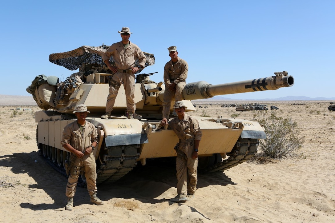 Clockwise from top left, 1st Lieutenant John Neail, tank commander, Cpl. Christian Bills, gunner, Lance Cpl. Robert Benaridez driver, Lance Cpl. Patrick Bellinger, loader, the crew for the M1A1 Abrams Main Battle Tank named “Star Lord” participated in Desert Scimitar aboard Marine Corps Air Ground Combat Center Twentynine Palms, Calif. Desert Scimitar enables 1st Marine Division to test and refine its command and control capabilities and ensures 1st Marine Division units remain committed to consistently improving the quality of their training efforts and their resultant warfighting capabilities.