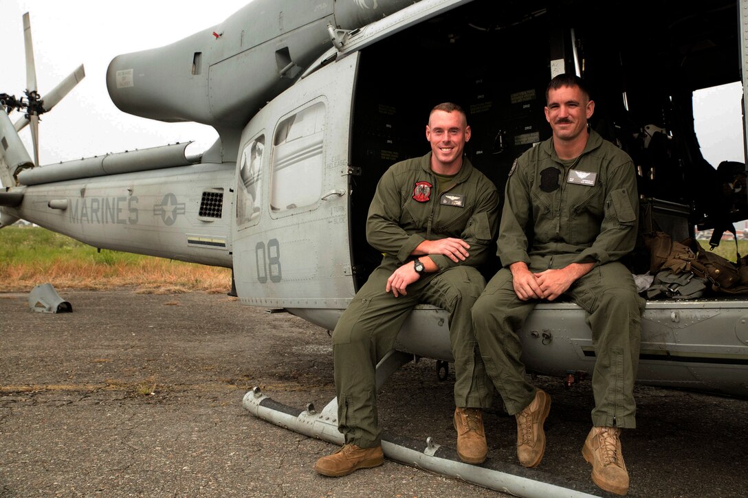 U.S. Marine Sgt. James L. Hibler, from Arlington, Texas, and Sgt. Ward M. Johnson IV, from Charleston, South Carolina, sit on a UH-1Y Huey at the Tribhuvan International Airport in Kathmandu, Nepal, May 9. Hibler and Johnson are crew chiefs with Marine Light Attack Helicopter Squadron 469 currently contributing to the joint-service humanitarian aid mission in Nepal under JTF 505, which is composed of service members from across the U.S. military. The task force responded with joint capabilities and relief supplies after the Nepalese government requested assistance from U.S. Agency for International Development following the 7.8 magnitude earthquake that struck their country April 25.