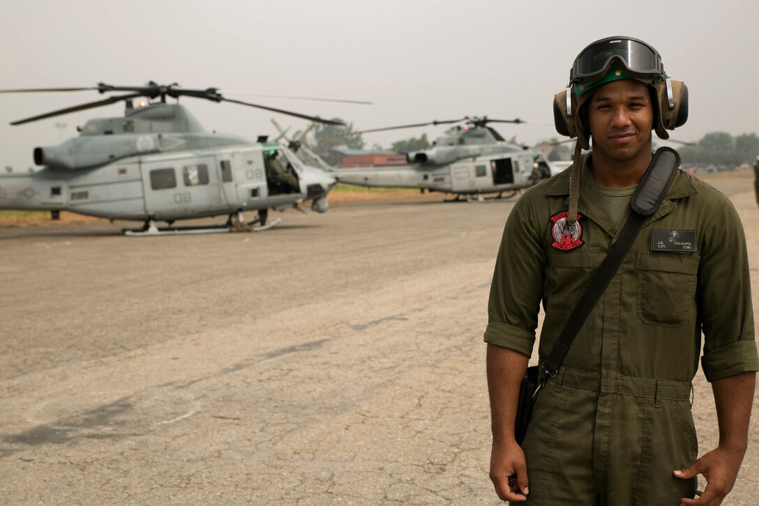 U.S. Marine Lance Cpl. Jesus Dislalopez, from Philadelphia, Pennsylvania, stands in front of three UH-1Y Hueys at the Tribhuvan International Airport in Kathmandu, Nepal, May 9. Dislalopez is an airframes mechanic with Marine Light Attack Helicopter Squadron 469 currently contributing to the joint-service humanitarian aid mission in Nepal under JTF 505, which is composed of service members from across the U.S. military. The task force responded with joint capabilities and relief supplies after the Nepalese government requested assistance from U.S. Agency for International Development following the 7.8 magnitude earthquake that struck their country April 25.