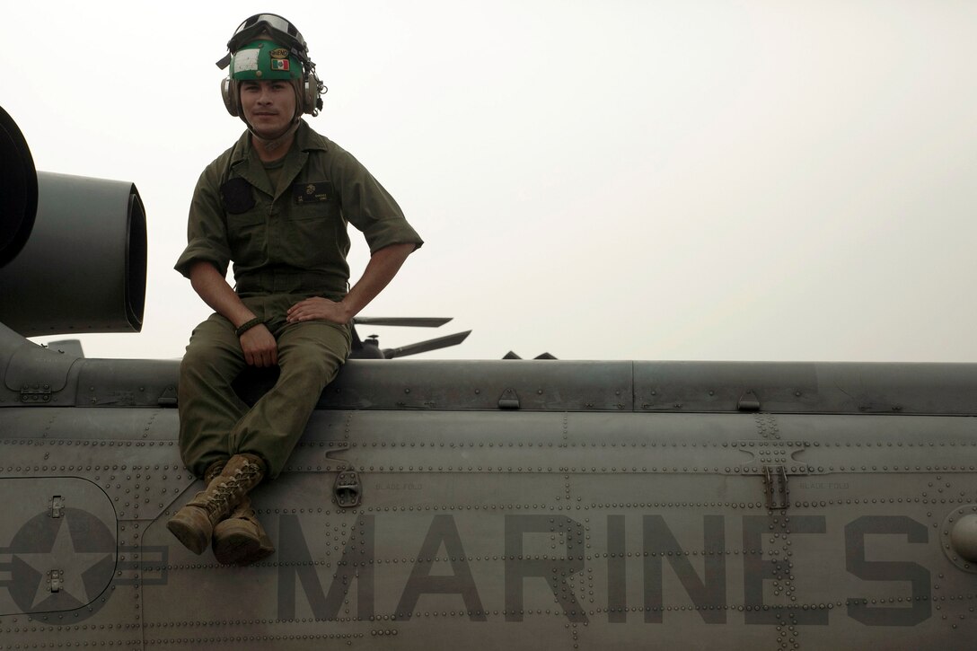 U.S. Marine Lance Cpl. James E. Sanchez, sits on top of a UH-1Y Huey at the Tribhuvan International Airport in Kathmandu, Nepal, May 9. Sanchez is an avionics electronics technician with Marine Light Attack Helicopter Squadron 469 currently contributing to the joint-service humanitarian aid mission in Nepal under JTF 505, which is composed of service members from across the U.S. military. The task force responded with joint capabilities and relief supplies after the Nepalese government requested assistance from U.S. Agency for International Development following the 7.8 magnitude earthquake that struck their country April 25.