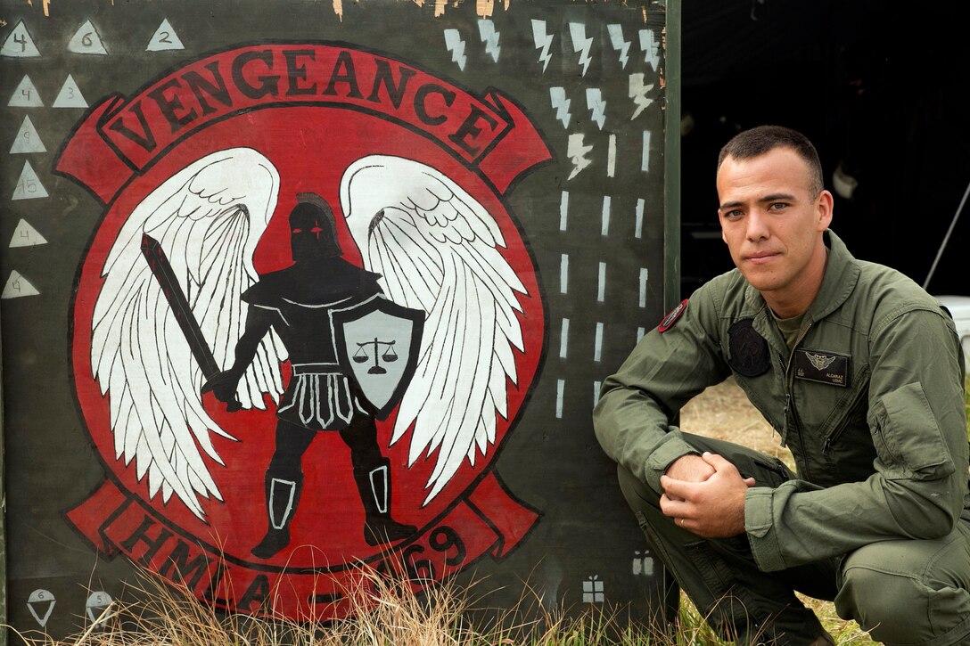U.S. Marine Sgt. Juan J. Alcaraz, from Yucca Valley, California, kneels in front of a HMLA-469 Vengeance sign at the Tribhuvan International Airport in Kathmandu, Nepal, May 9. Alcaraz is a crew chief with Marine Light Attack Helicopter Squadron 469 currently contributing to the joint-service humanitarian aid mission in Nepal under JTF 505, which is composed of service members from across the U.S. military. The task force responded with joint capabilities and relief supplies after the Nepalese government requested assistance from U.S. Agency for International Development following the 7.8 magnitude earthquake that struck their country April 25.