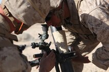 PFC Michael Ainsworth, a mortarman with Weapons Company, 3rd Battalion, 5th Marine Regiment adjusts the sights of the 81 mm mortar system during a combined-arms raid at Army National Training Center Fort Irwin, April 11, 2015. The raid was conducted by 1st Light Armored Reconnaissance Battalion as part of exercise Desert Scimitar 2015.