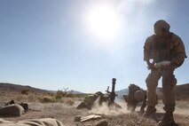 Mortarmen with Weapons Company, 3rd Battalion, 5th Marine Regiment fire mortar rounds during a combined-arms raid at Army National Training Center Fort Irwin, April 11, 2015. The raid was conducted by 1st Light Armored Reconnaissance Battalion as part of exercise Desert Scimitar 2015.