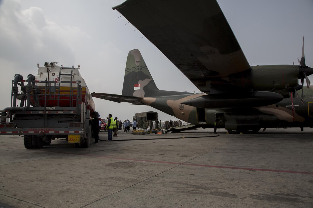 Nepalese service members work with Singaporean airmen to move relief supplies at Tribhuvan International Airport, Kathmandu, Nepal, May 9. The Nepalese government requested the U.S. government’s assistance after a 7.8 magnitude earthquake struck the country, April 25. The U.S. government ordered Joint Task Force 505 to provide unique capabilities to assist Nepal. 
