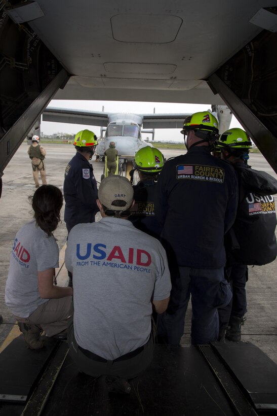 Members from the U.S. Agency for International Development and firefighters from Fairfax County observe a U.S. Marine Corps MV-22 Osprey from Joint Task Force 505 at Tribhuvan International Airport, Kathmandu, Nepal, May 9. The Nepalese government requested the U.S. government’s assistance after a 7.8 magnitude earthquake struck the country, April 25. The U.S. government ordered JTF 505 to provide unique capabilities to assist Nepal.
