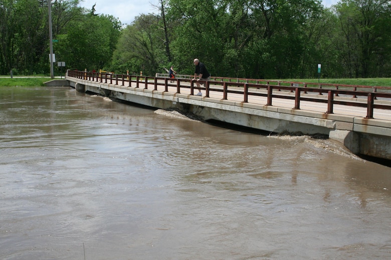 High water along Salt Creek in Lincoln, Nebraska nears the surface of a pedestrian bridge. Heavy rainfall on May 6, set record and near-record stages across the Salt Creek Basin.