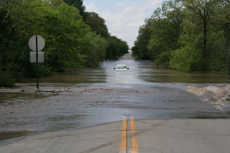A van is abandoned near Pioneers Park in Lincoln, Nebraska, after the owner attempted to drive through flood waters on May 7, 2015. The high water led to several closed roads in the local area.