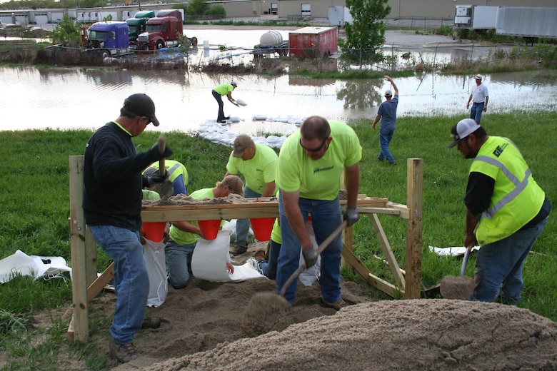 Crews fill sandbags and construct a ring of sand bags around a boil that formed along the Salt Creek Levee across from the Waste Water Treatment Plant in Lincoln, Nebraska, on May 7, 2015.