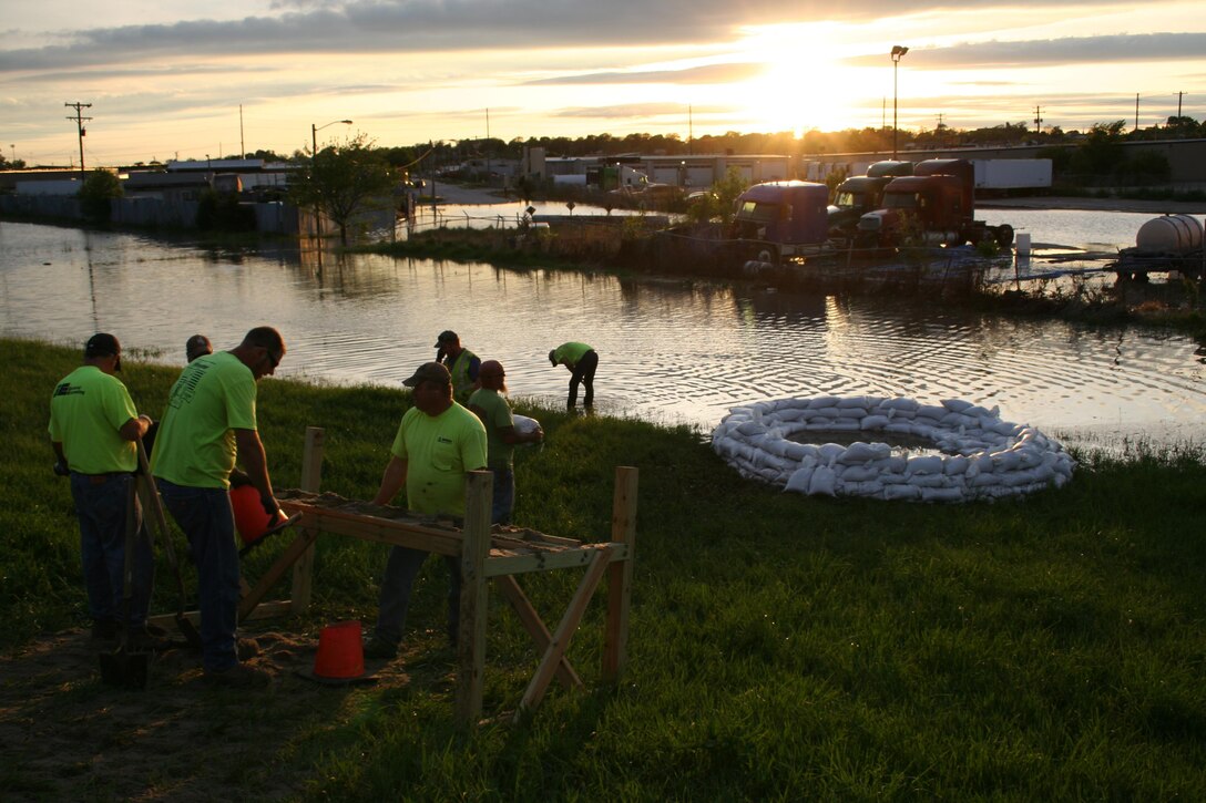 Crews fill sandbags to construct a ring around boils on a Sand Creek Levee in Lincoln, Nebraska, following record rainfall on May 6, 2015.