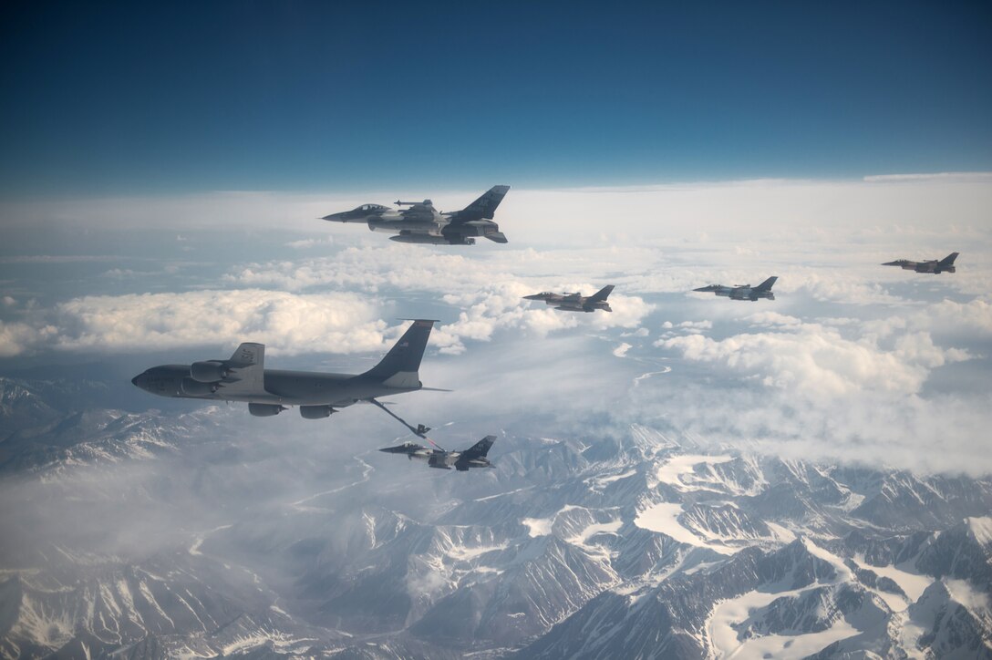 U.S. Air Force F-16 Fighting Falcons from the 18th Aggressor Squadron at Eielson Air Force Base, Alaska, refuel behind a KC-135 Stratotanker assigned to the Pennsylvania Air National Guard’s 171st Air Refueling Wing, while flying over the Joint Pacific Alaska Range Complex May 11, 2015, during Red Flag-Alaska (RF-A) 15-2. RF-A allows participating units to exchange tactics, techniques and procedures as well as improve interoperability. (U.S. Air Force photo by Staff Sgt. Shawn Nickel/Released)