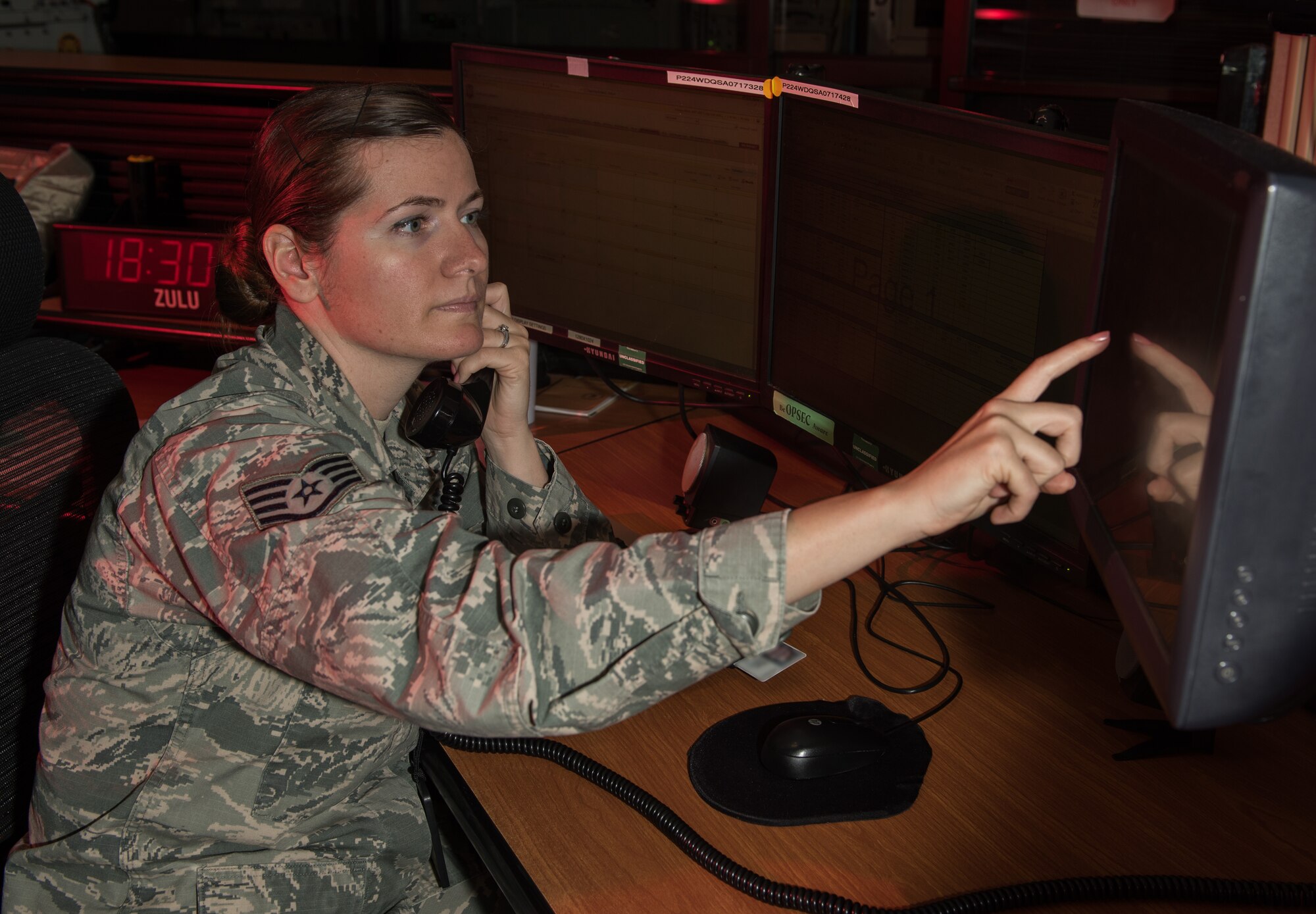 Staff Sgt. Brittainy Ward, 940th Wing senior emergency action controller and reports manager, communicates with base personnel, March 23, 2015, Beale Air Force Base, California. The command post is part of the Air Force’s global network of command and control nerve centers that respond to medical, weather, or aircraft emergencies. (U.S. Air Force photo by Staff Sgt. Brenda Davis/Released)

