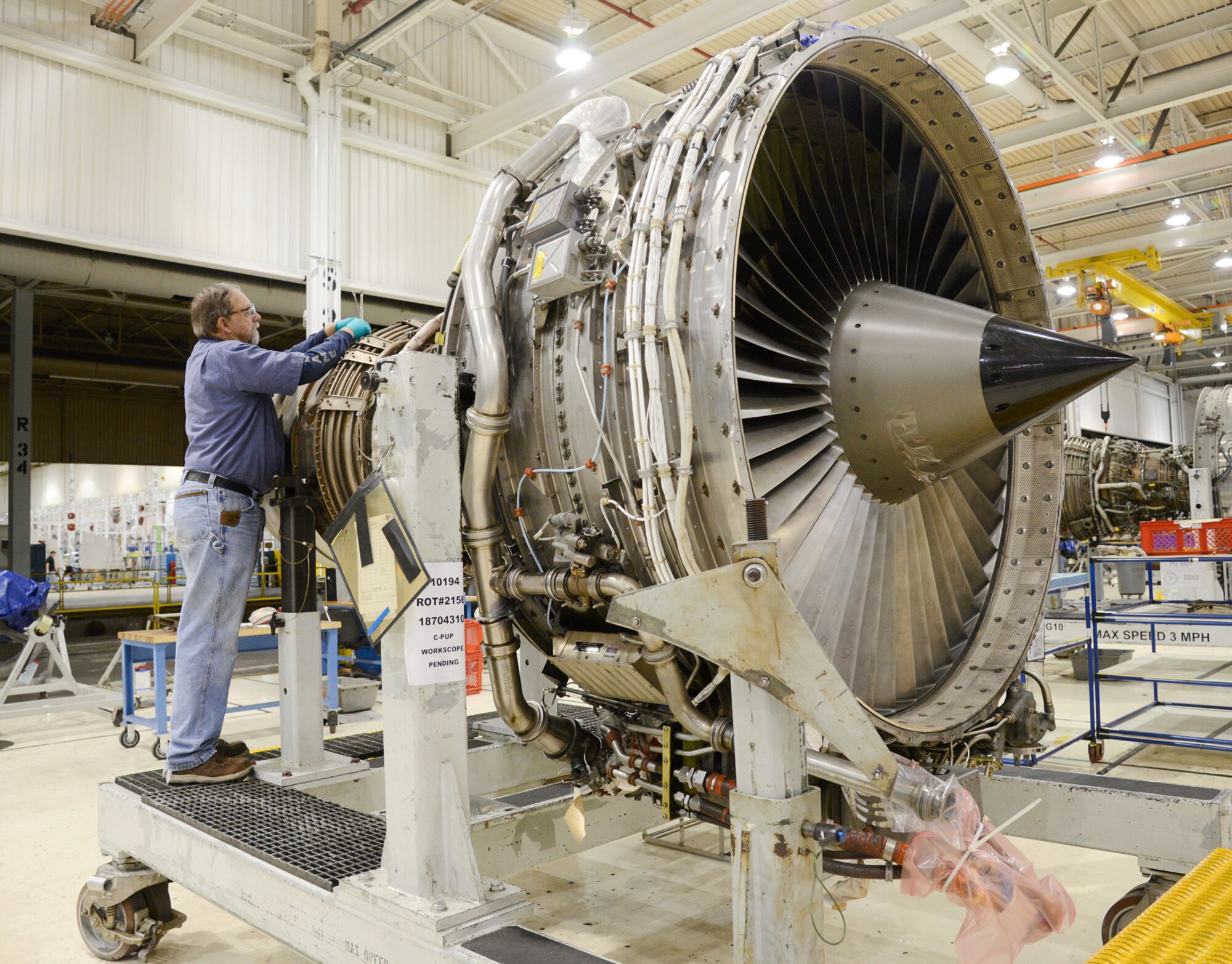James Bunyard, an engine mechanic with the 548th Propulsion Maintenance Squadron, works on an F108 engine at Bldg. 9001 of the Oklahoma City Air Logistic Complex at Tinker AFB, Oklahoma. A proposed energy savings performance contract for the complex has a possible scope of at least 60 buildings and 10 million square feet. (U.S. Air Force photo by Kelly White/Released)