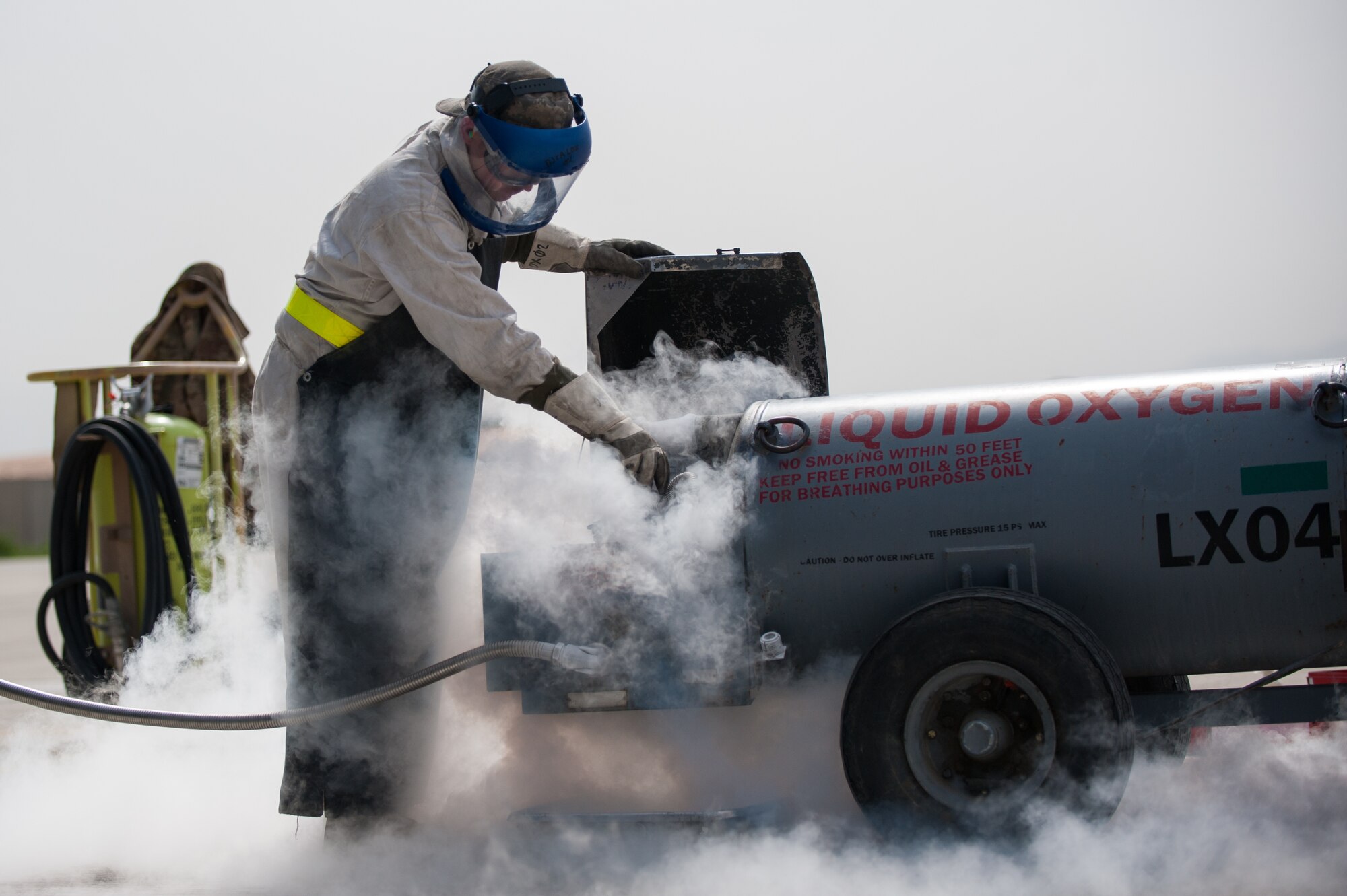 U.S. Air Force Airman 1st Class Ryan Munchel, assigned to the 455th Expeditionary Aircraft Maintenance Squadron, transfers liquid oxygen to an LOX reservoir in a C-130J Super Hercules aircraft on the flight line at Bagram Airfield, Afghanistan, May 5, 2015. The 455th EAMXS ensure Super Hercules on Bagram are prepared for flight and return them to a mission-ready state once they land. (U.S. Air Force photo by Tech. Sgt. Joseph Swafford/Released)