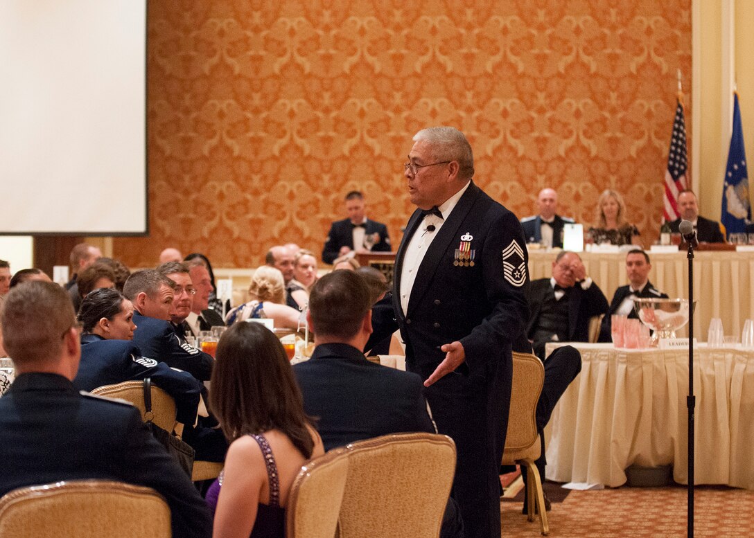 Retired Chief Master Sgt. Bob Vasquez, director of the freshman character development seminar at the Air Force Academy's Center for Character and Leadership Development, gives a speech during the 90th Missile Wing dining-out on May 8, 2015. The dining-out is a formal dinner hosted by the 90th MW to provide military members and their spouses, as well as civilians, the opportunity to meet socially, and create bonds of friendships in an atmosphere which promotes fellowship, camaraderie and esprit de corps. (U.S. Air Force photo by Lan Kim)
