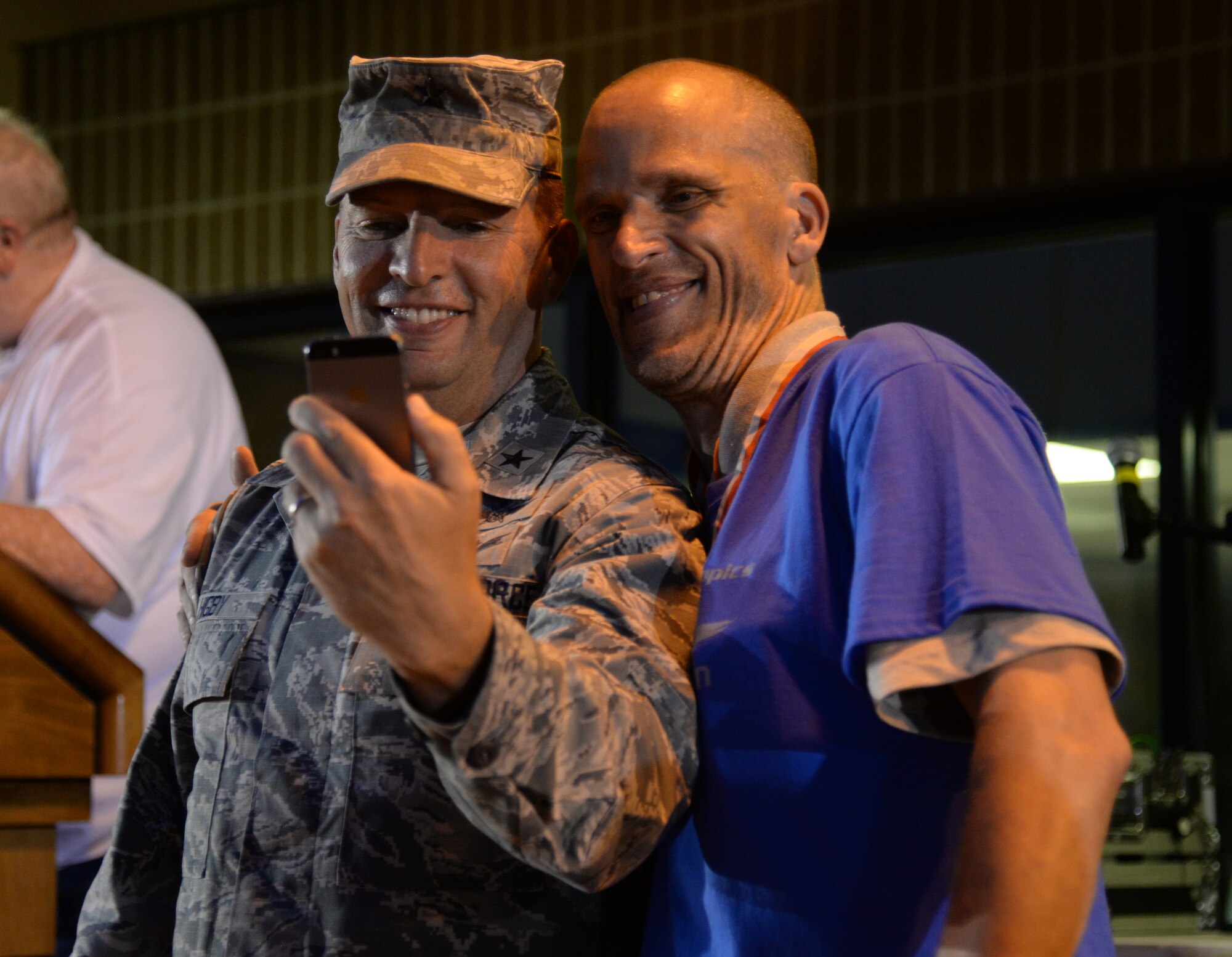 Brig. Gen. Patrick Higby, 81st Training Wing commander, takes a photo with an athlete at the 2015 Mississippi State Special Olympics Victory Dance, May 9, 2015, Keesler Air Force Base, Miss. Approximately 752 athletes competed in 55 sports, ranging from aquatics to track and field events throughout the two day event. More than 2,500 Airmen and civilian volunteers and 266 coaches helped make the event a success. This year was the 29th year Keesler has hosted the event. (U.S. Air Force photo by Senior Airman Holly Mansfield)