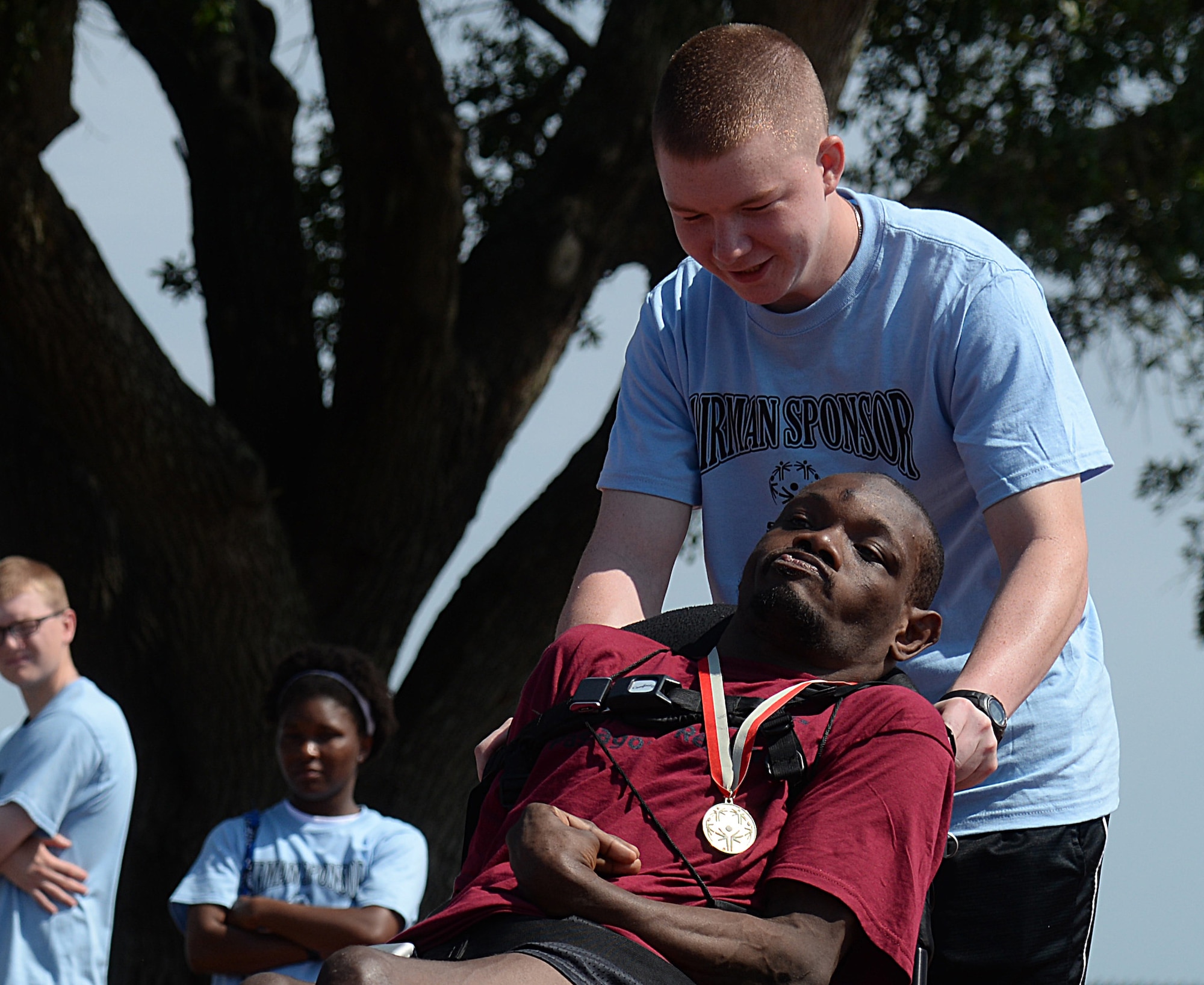 An Airman sponsor from the 81st Training Group helps an athlete to the wheelchair race starting line at the 2015 Mississippi State Special Olympics, May 9, 2015, Keesler Air Force Base, Miss. Approximately 752 athletes competed in 55 sports, ranging from aquatics to track and field events throughout the two day event. More than 2,500 Airmen and civilian volunteers and 266 coaches helped make the event a success. This year was the 29th year Keesler has hosted the event. (U.S. Air Force photo by Senior Airman Holly Mansfield)