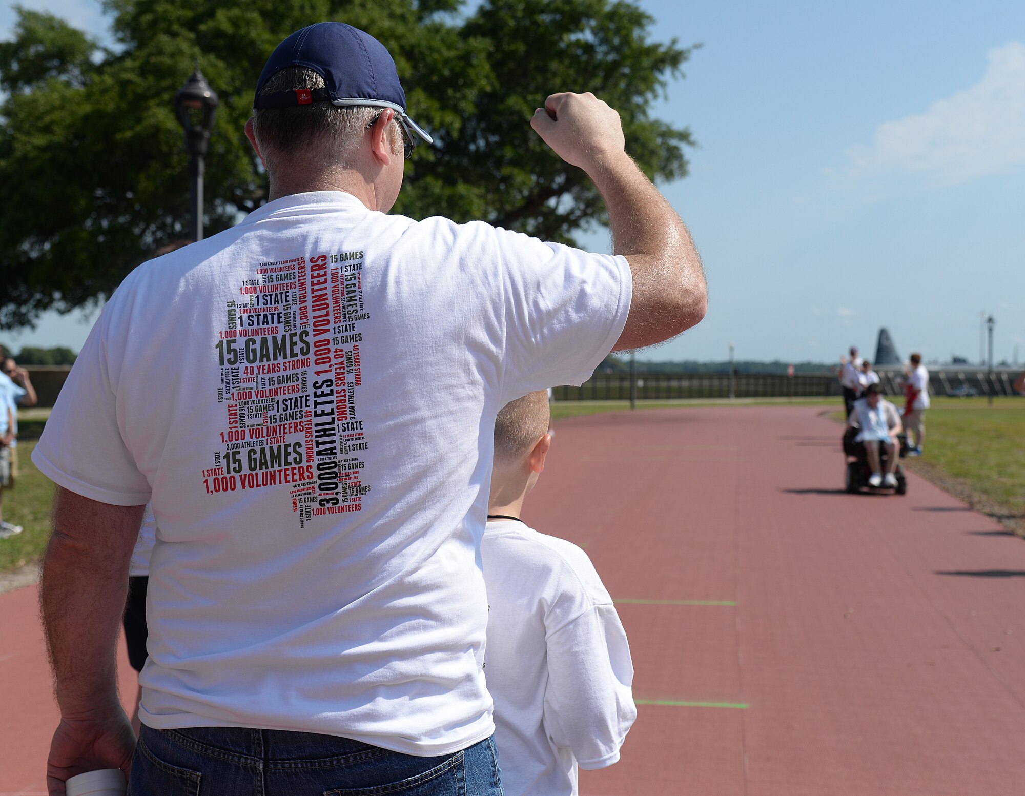 Crowd members cheer on athletes at the 2015 Mississippi State Special Olympics, May 9, 2015, Keesler Air Force Base, Miss. Approximately 752 athletes competed in 55 sports, ranging from aquatics to track and field events throughout the two day event. More than 2,500 Airmen and civilian volunteers and 266 coaches helped make the event a success. This year was the 29th year Keesler has hosted the event. (U.S. Air Force photo by Senior Airman Holly Mansfield)
